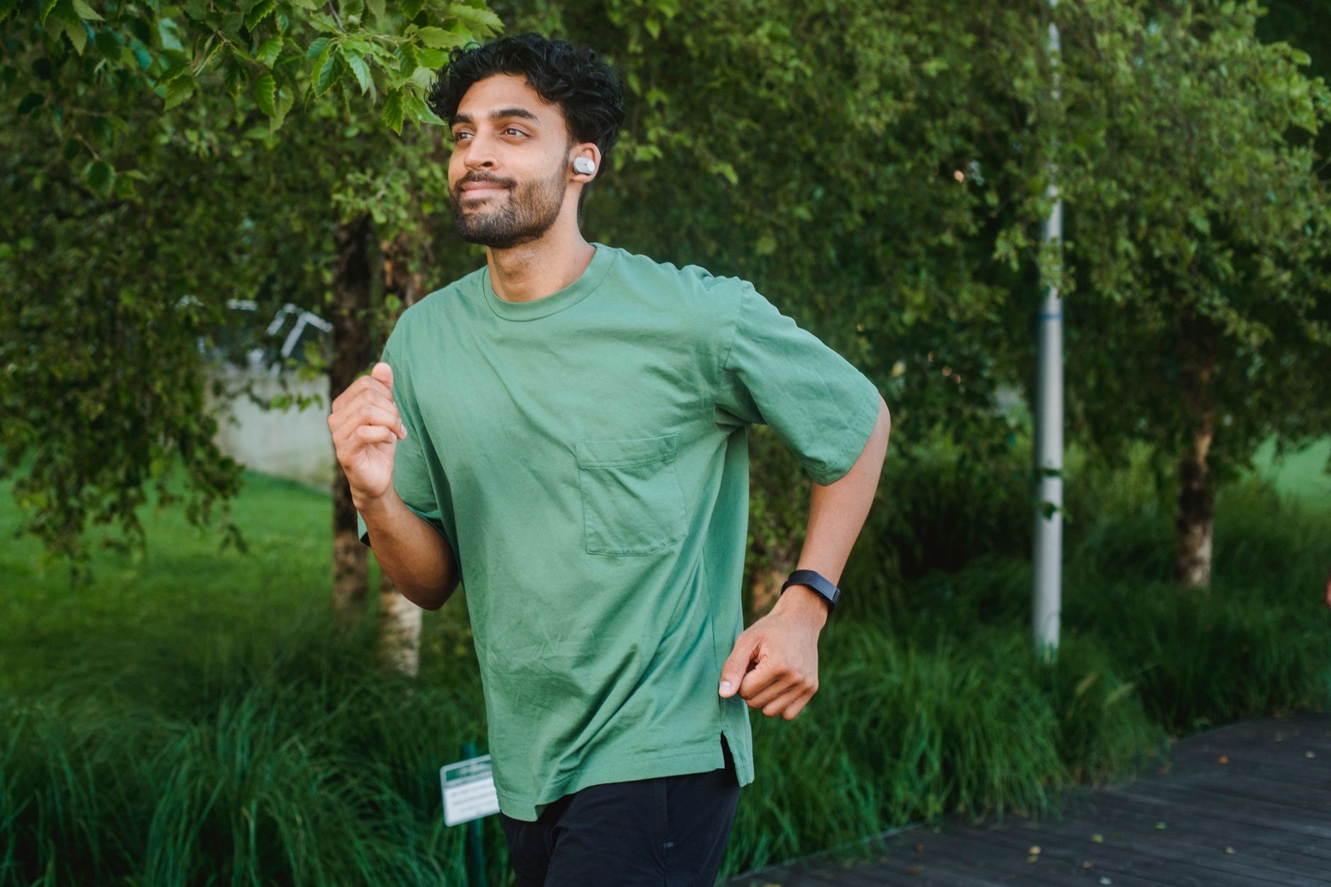 A person exercising with wireless earbuds