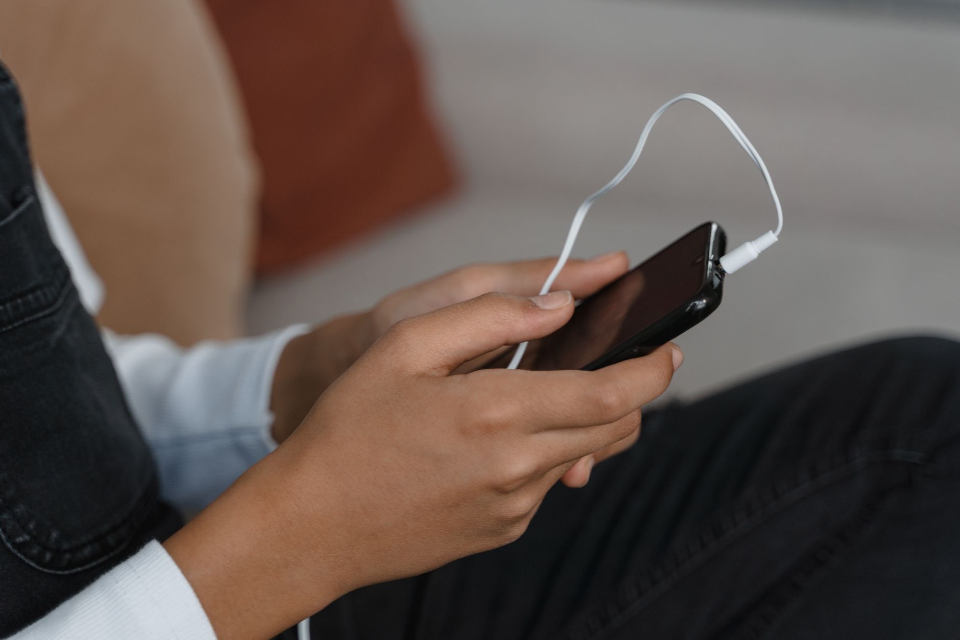 Wireless earbuds beside a smartphone for pairing