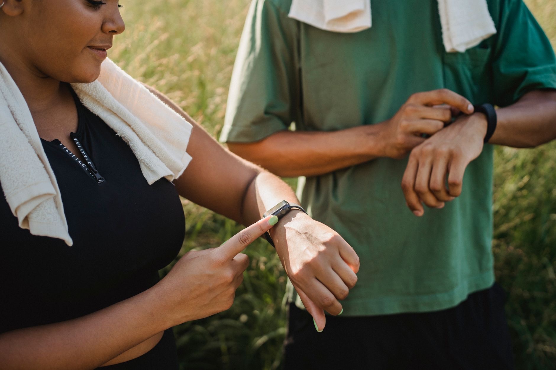 Person checking a fitness watch outdoors
