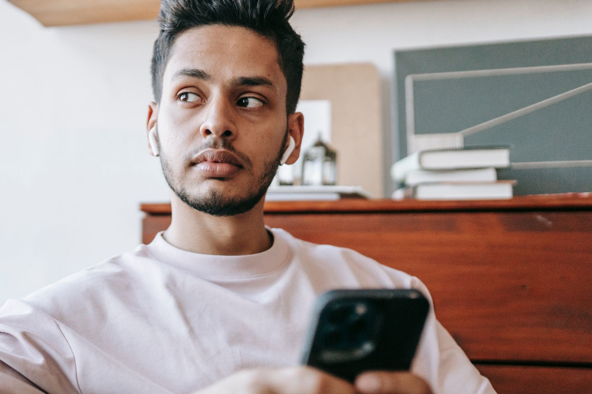 Wireless earbuds next to a smartphone