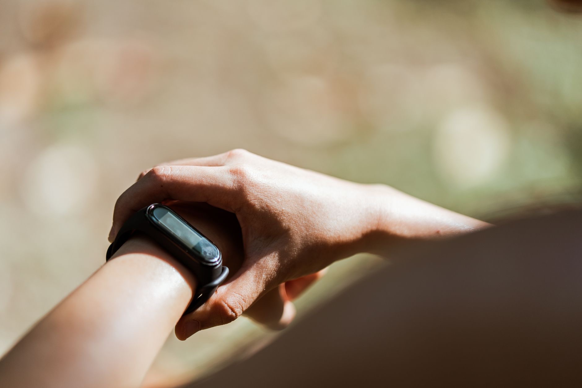 A close-up of a smartwatch on a small wrist