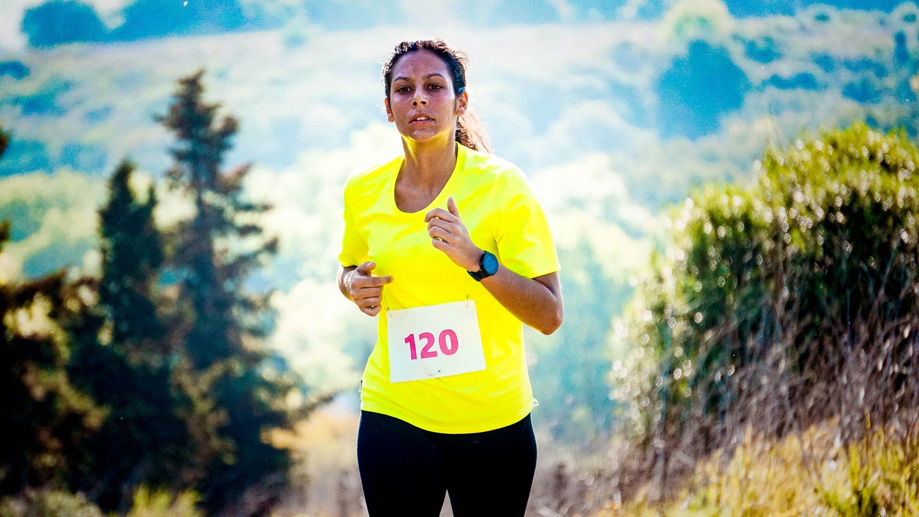 Person jogging on a trail wearing a watch