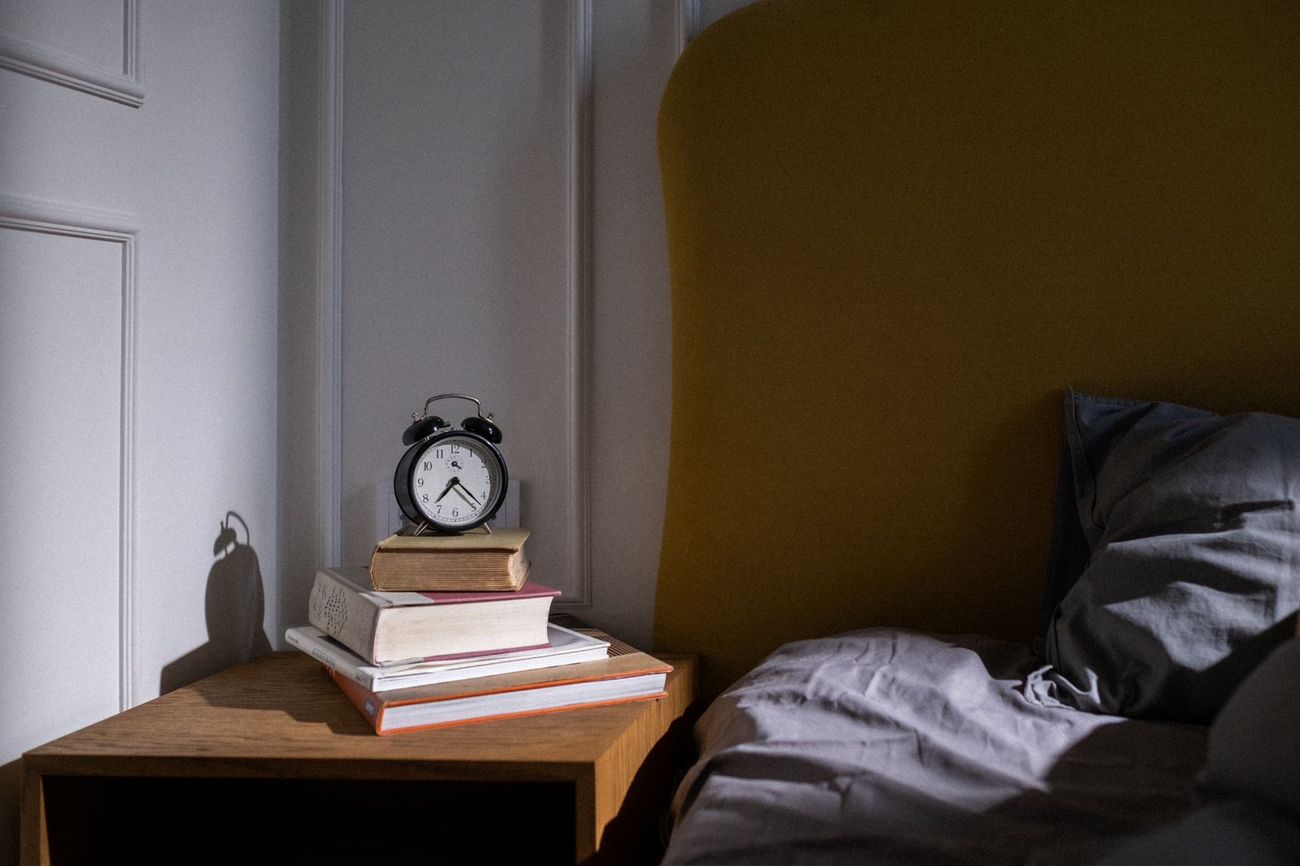Smartwatch on a nightstand beside a bed