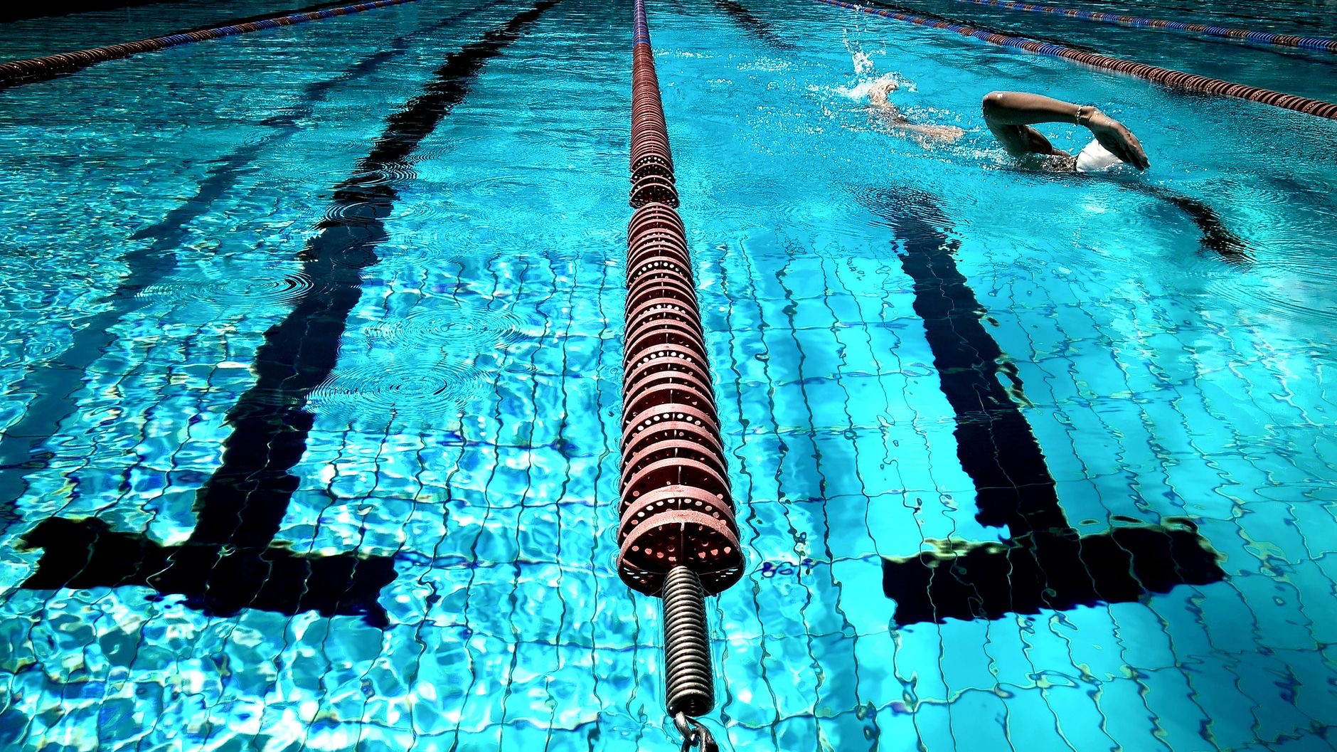 Swimmer in a pool with water splashing