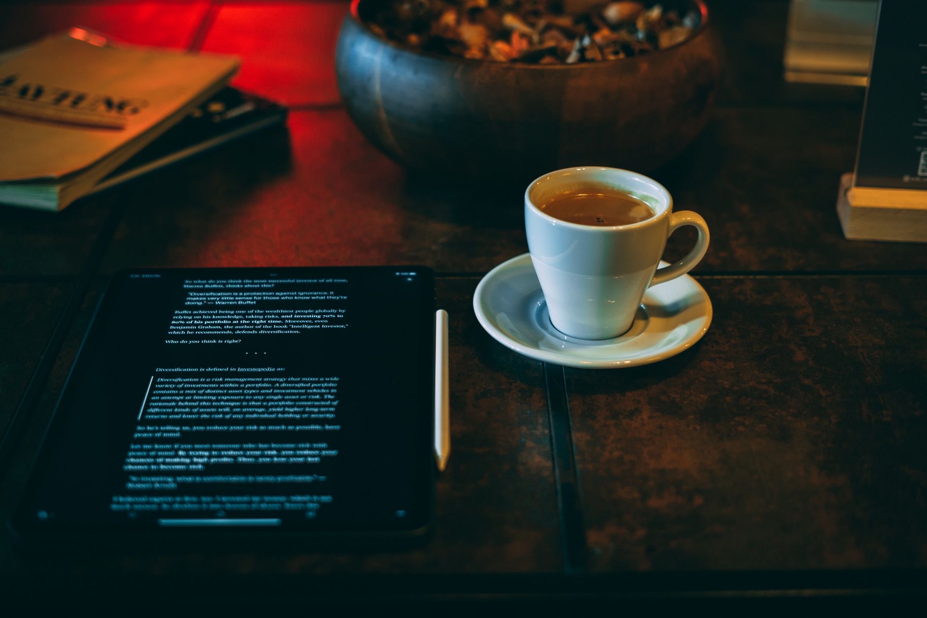 Tablet resting on a table beside a coffee