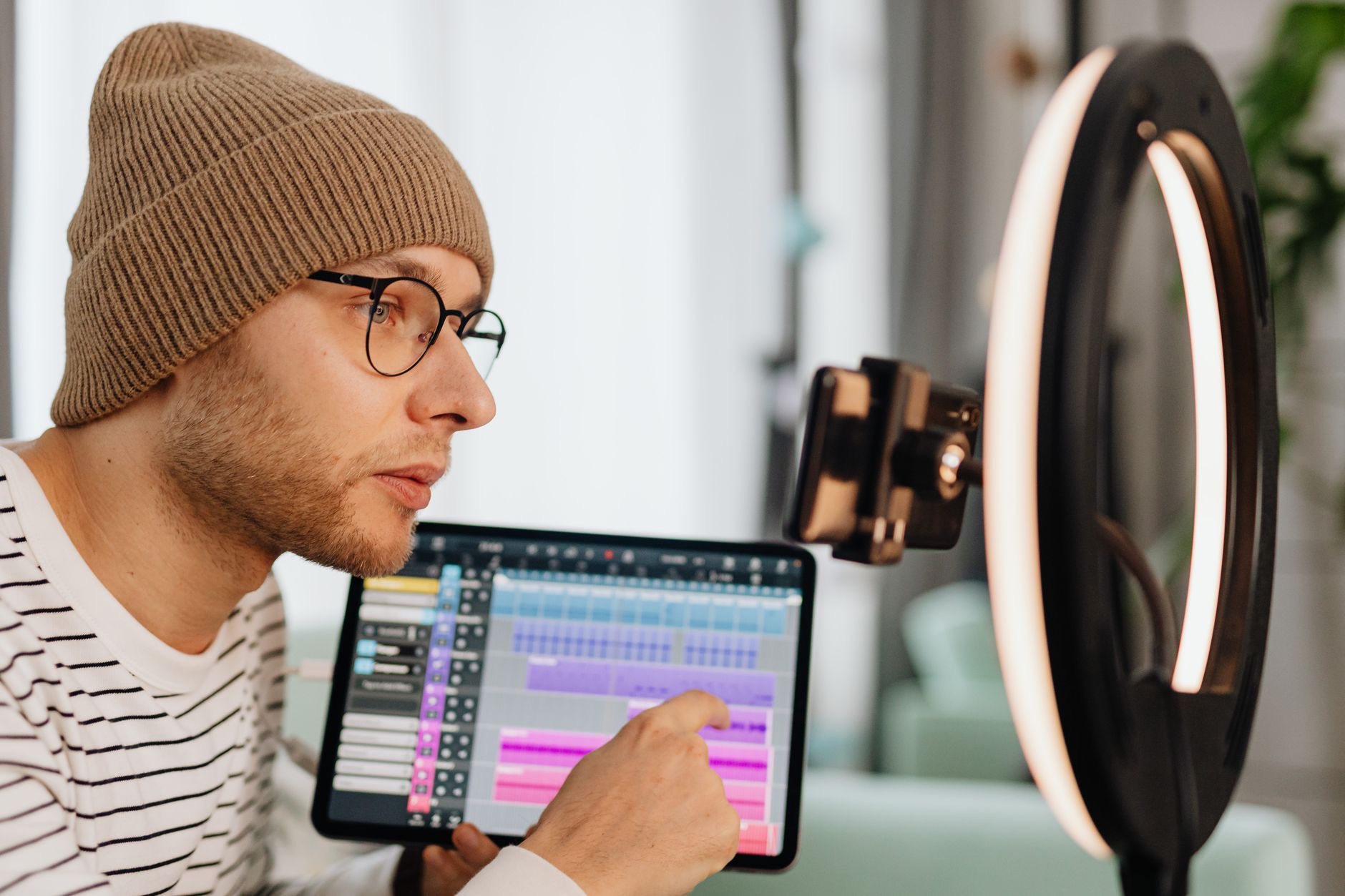 Creator working on a tablet with headphones