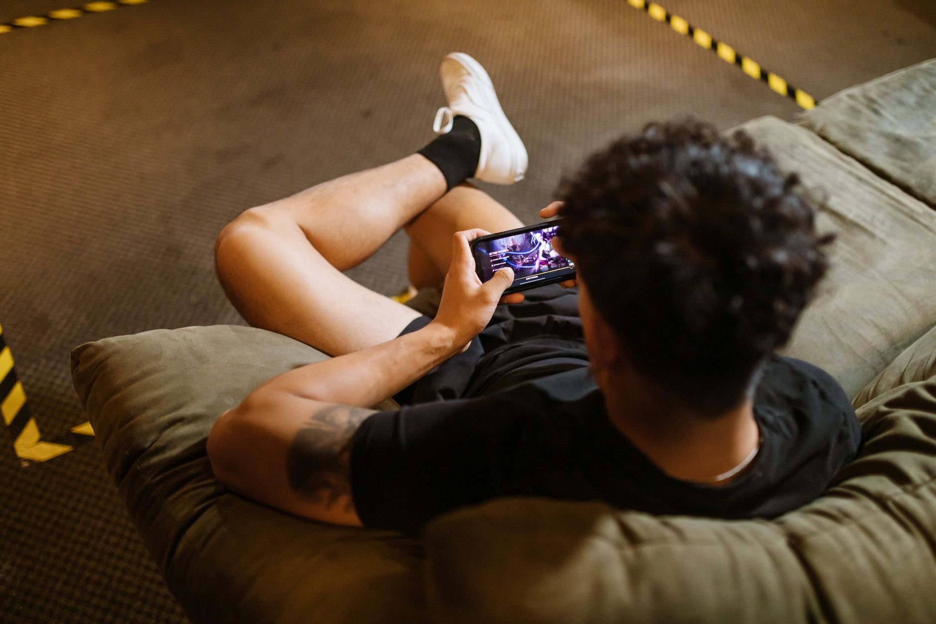 Person relaxing while gaming on a phone