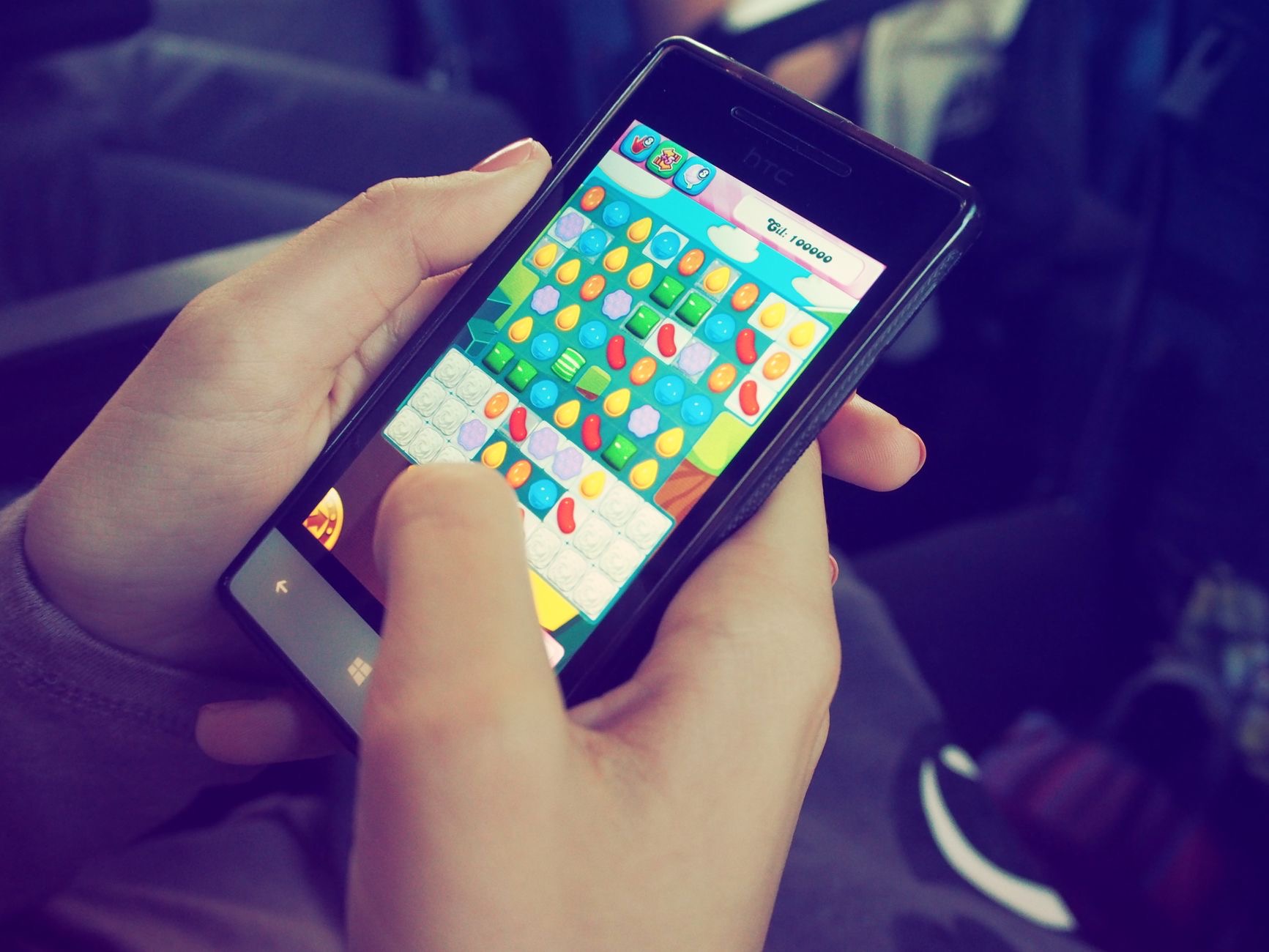 Person playing a game on an iPhone held in both hands