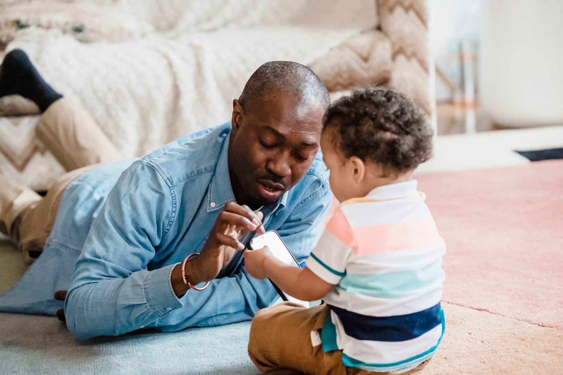 Parent and child looking at a phone together