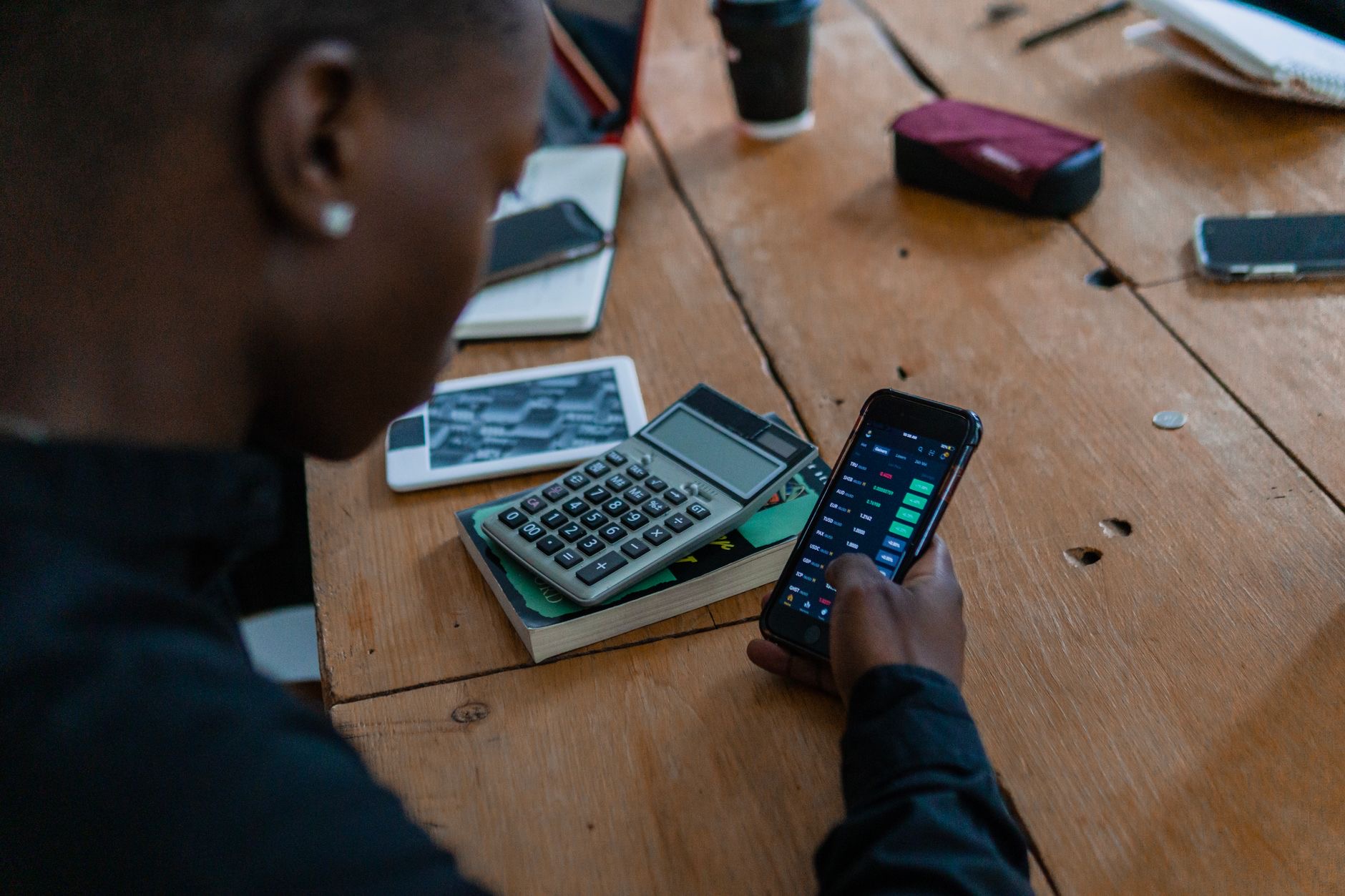 A person using a smartphone at a table