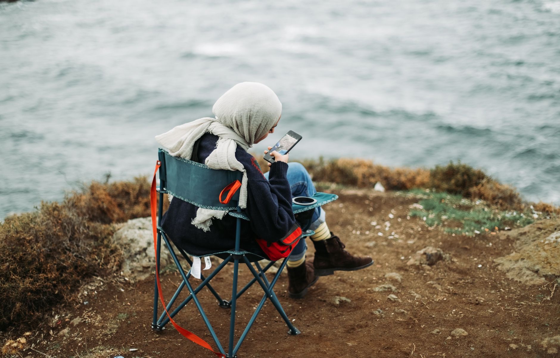 Traveler using a smartphone in a scenic location