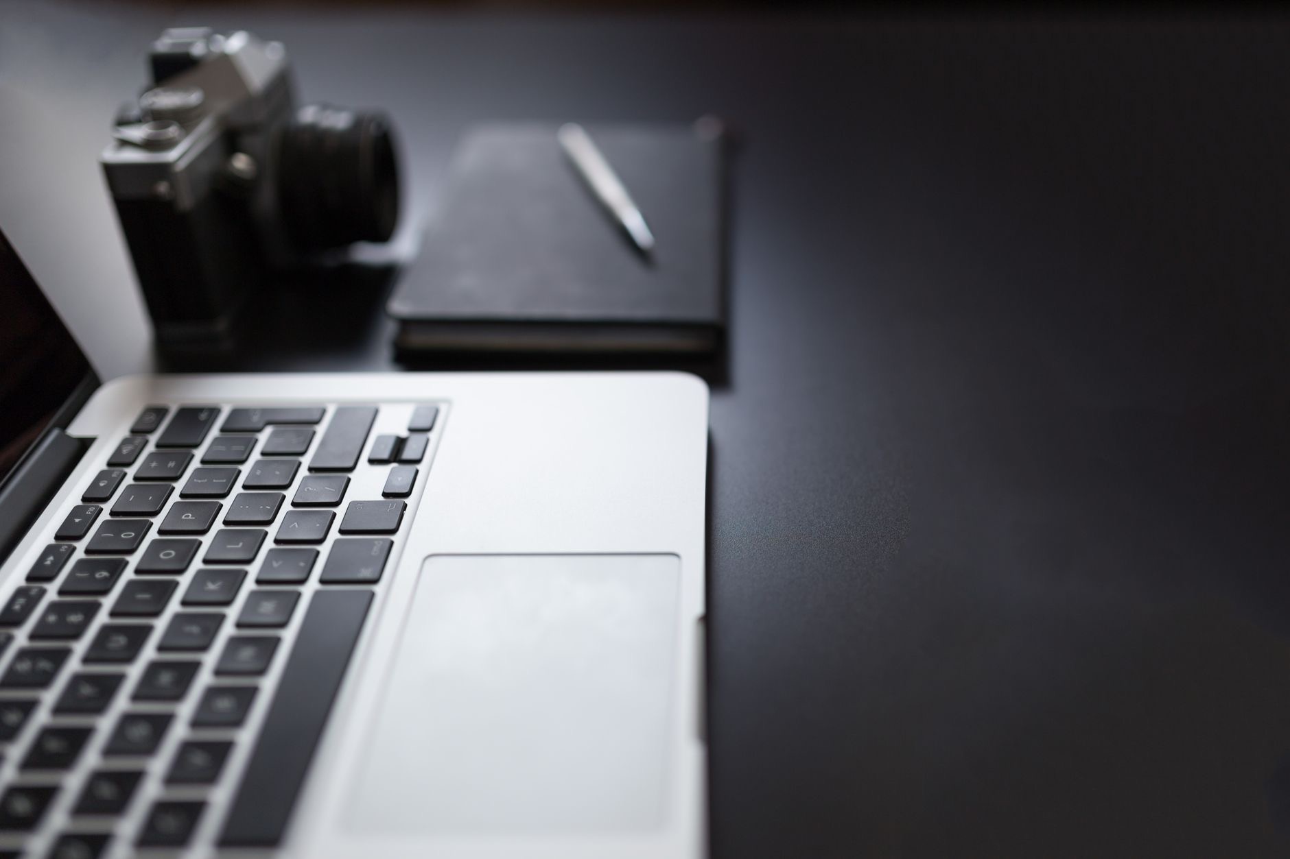 Creative desk with a laptop and camera