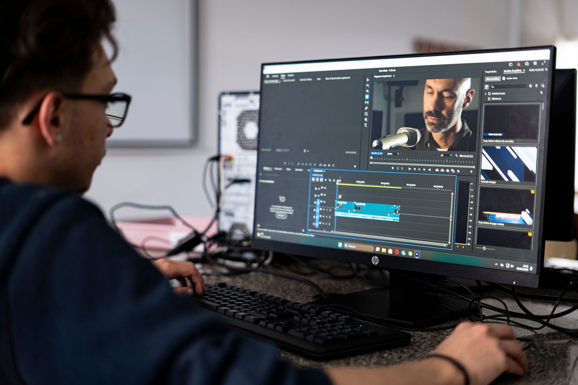 Person editing footage on a computer