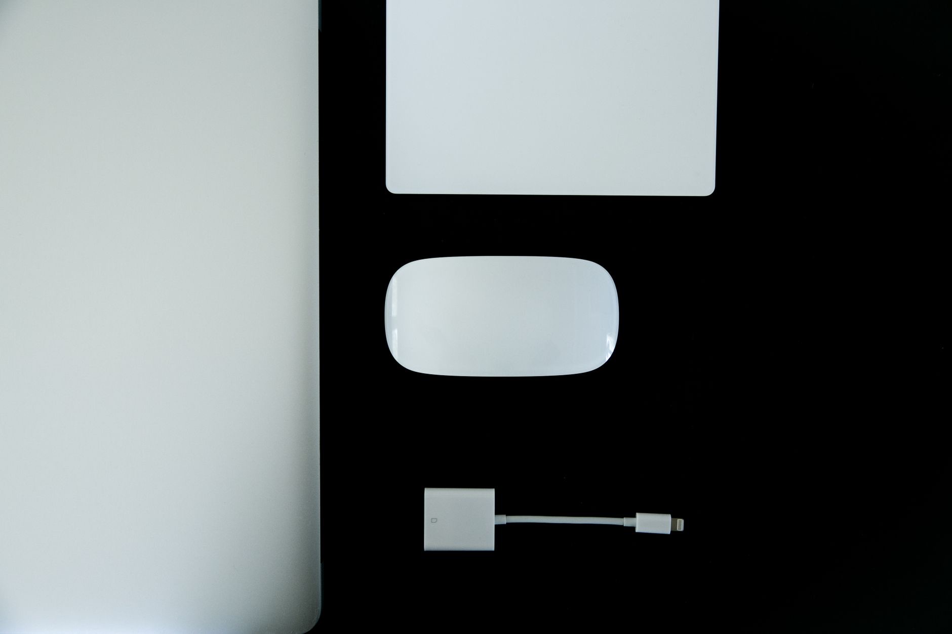 MacBook on a clean desk with accessories including a USB hub and keyboard