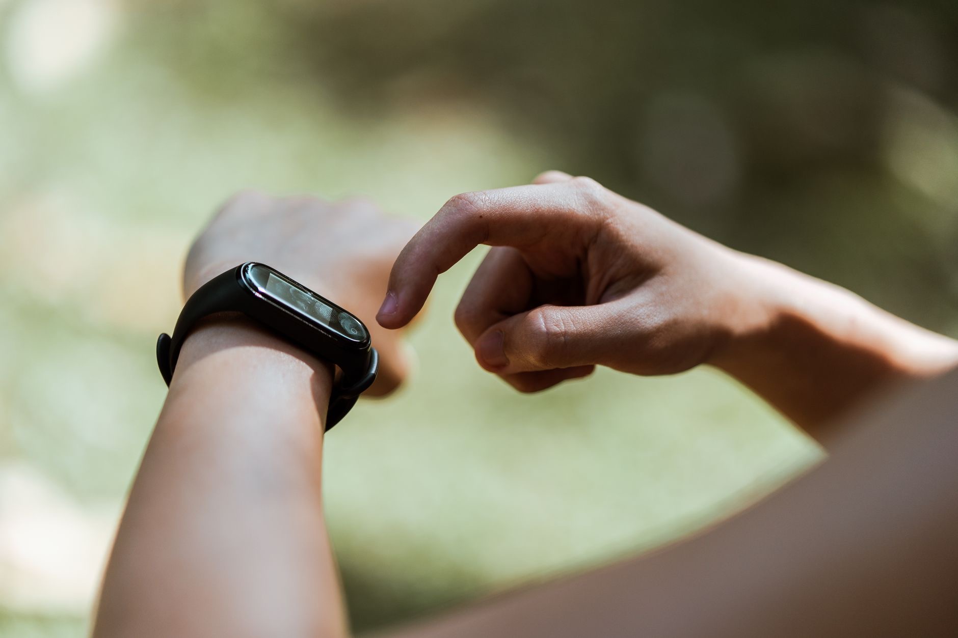 Person checking their pulse on a smartwatch after exercise