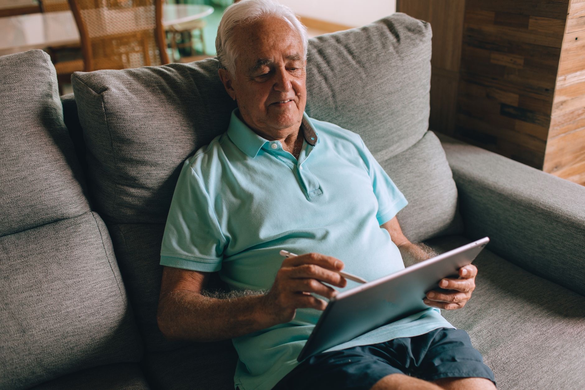 Person relaxing while using a tablet