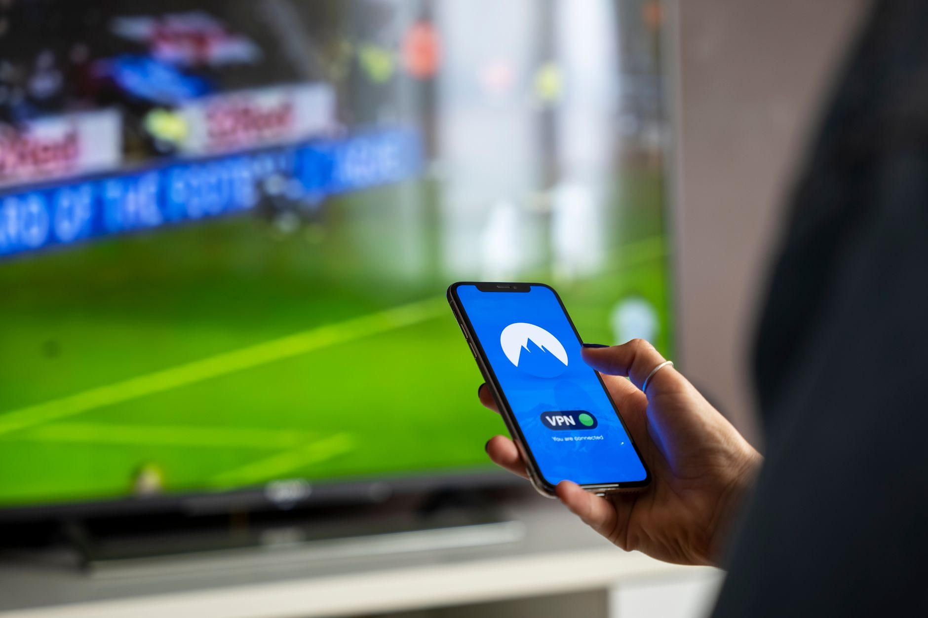 Television showing a photo with a streaming device beside it