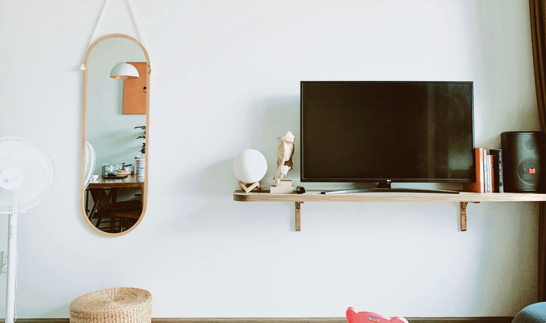 iPhone screen being mirrored onto a large television in a living room
