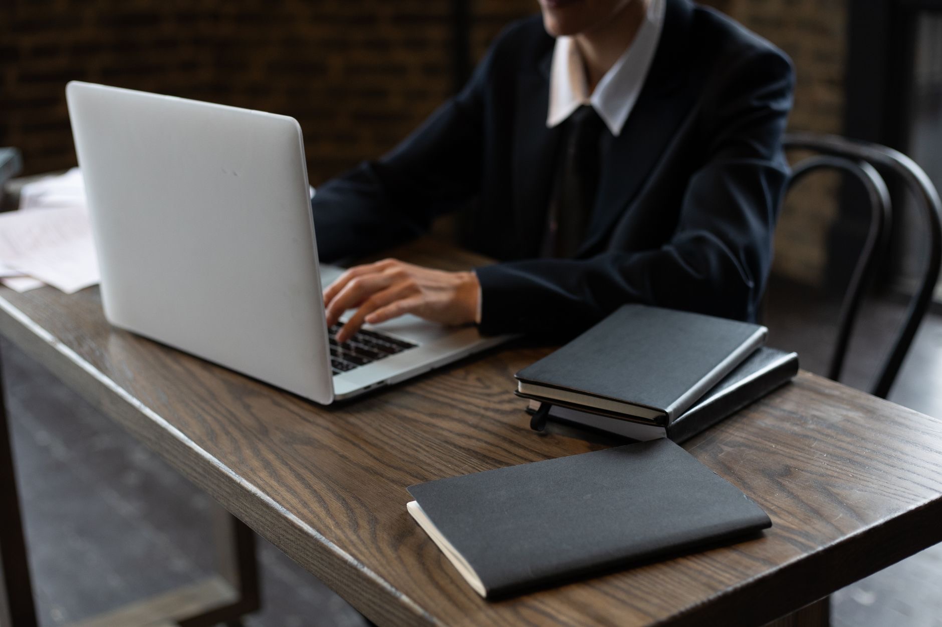 A person using a laptop at a desk