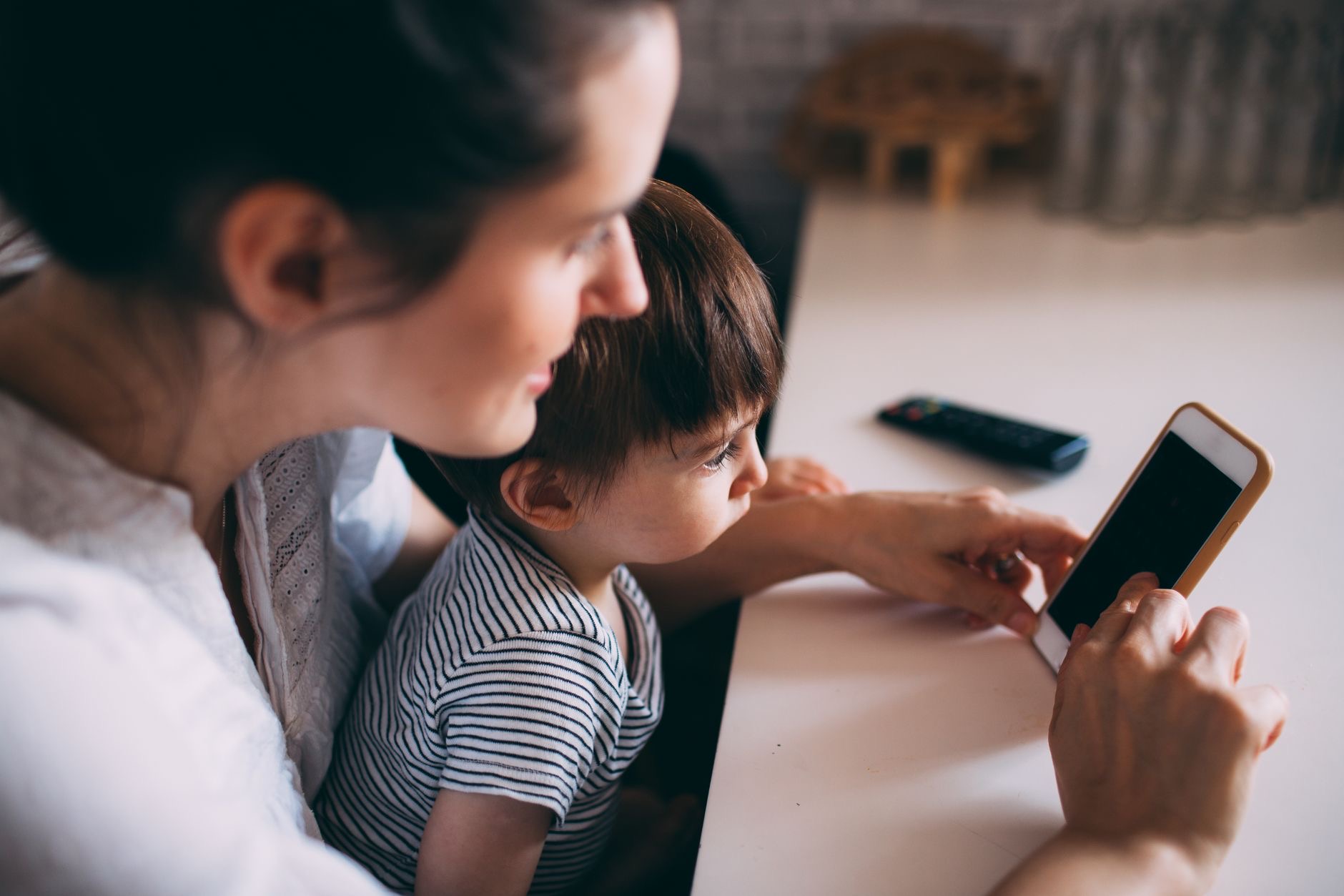 Parent and child looking at an iPhone screen together