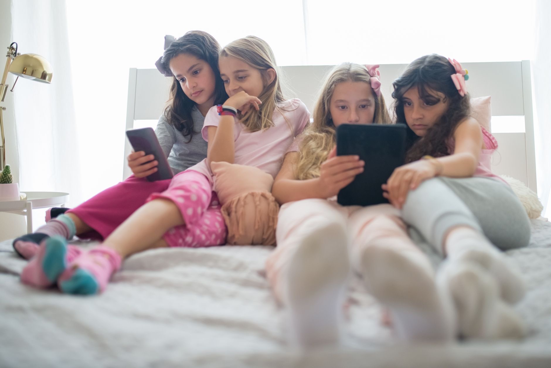 Family sitting together each using an Apple device at home