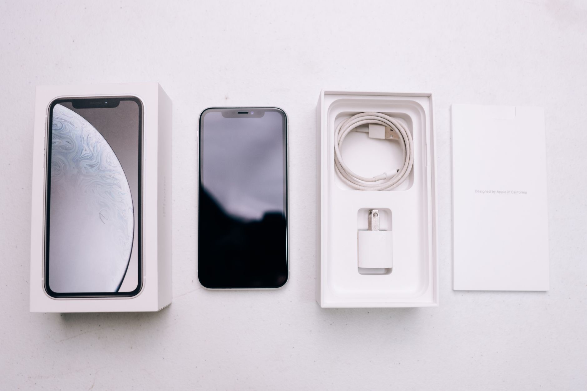 A person unboxing a new smartphone