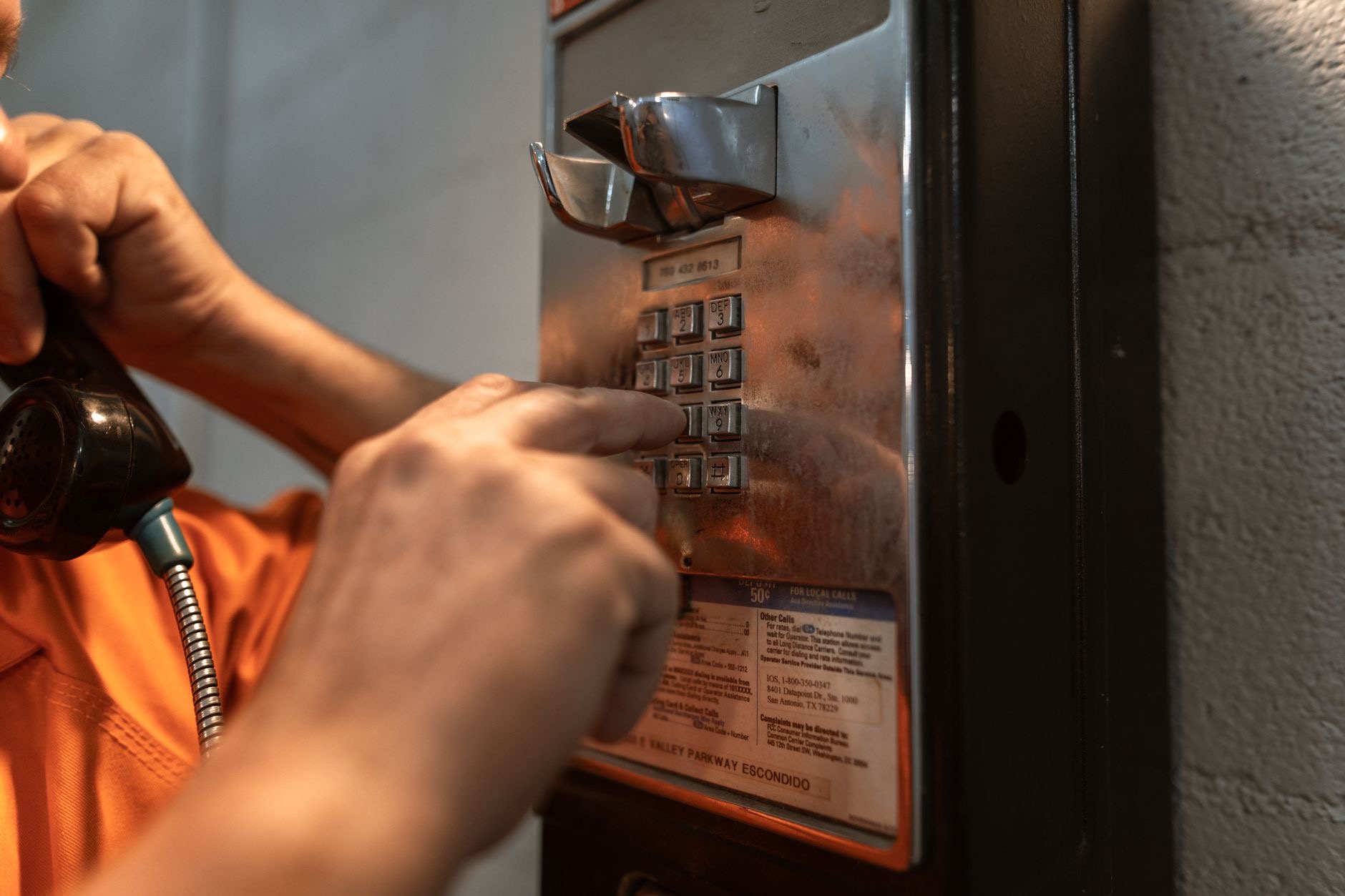 A hand pressing a button on a smartphone