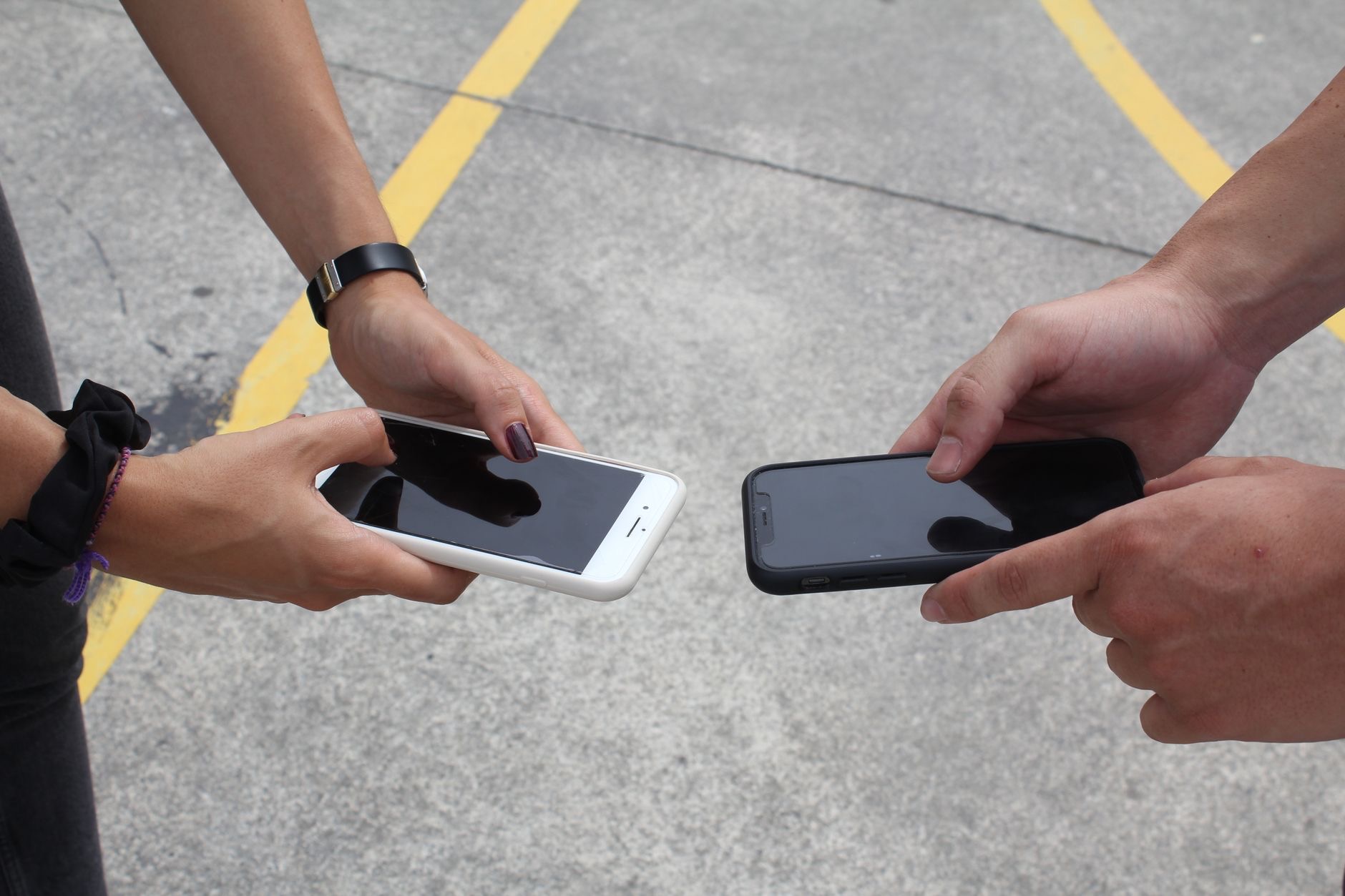 People sharing content between phones