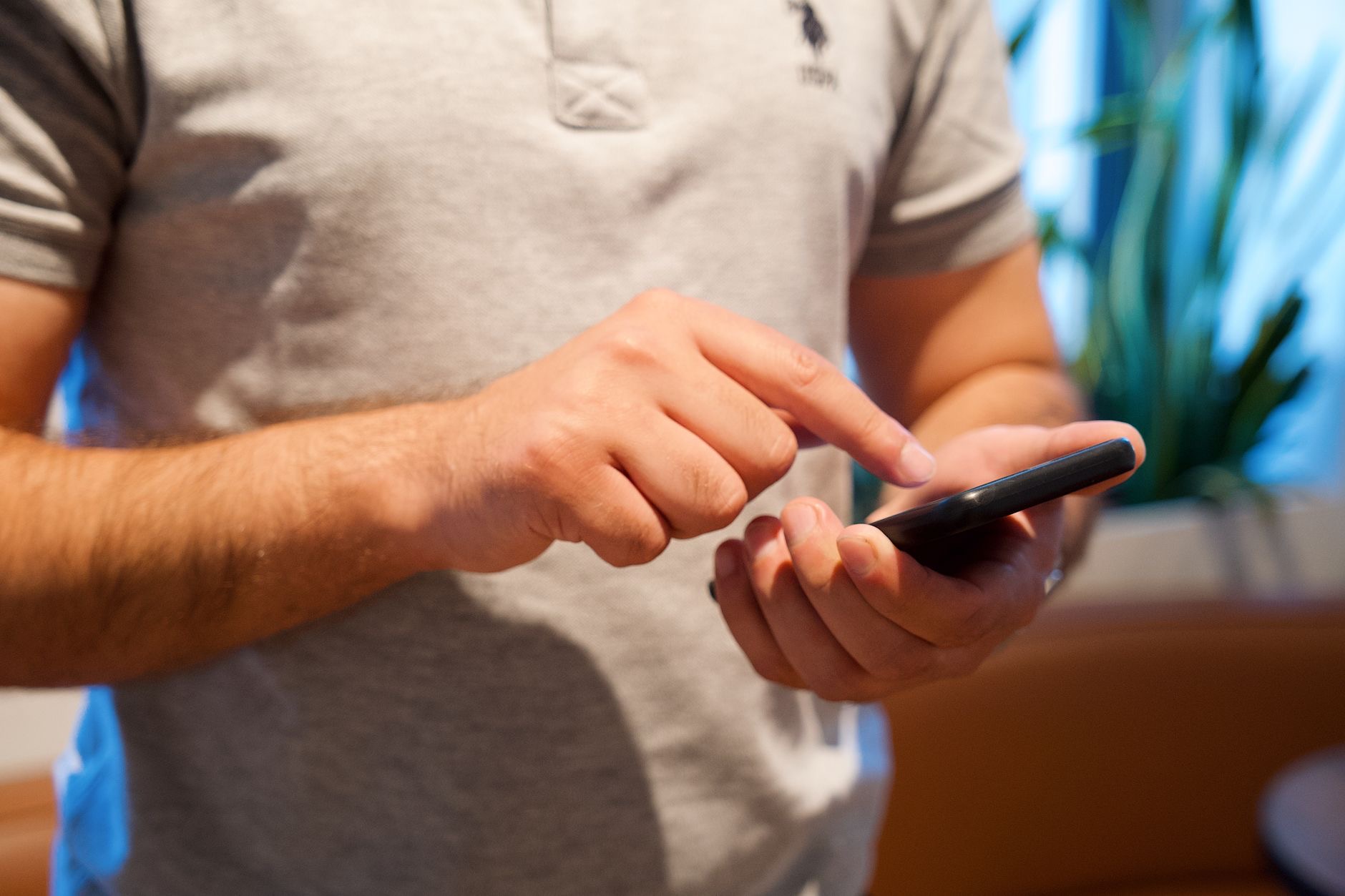 A person using a smartphone with both hands