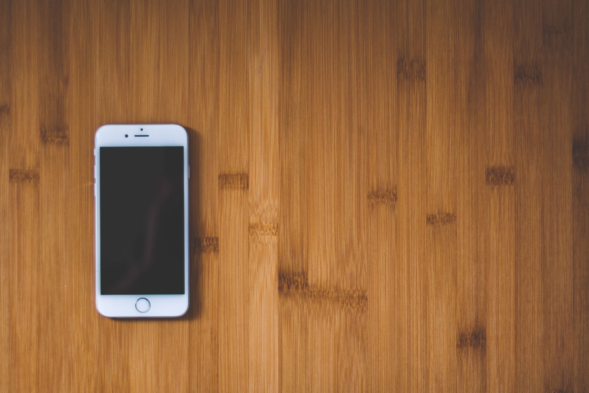 iPhone resting on a desk showing the screen