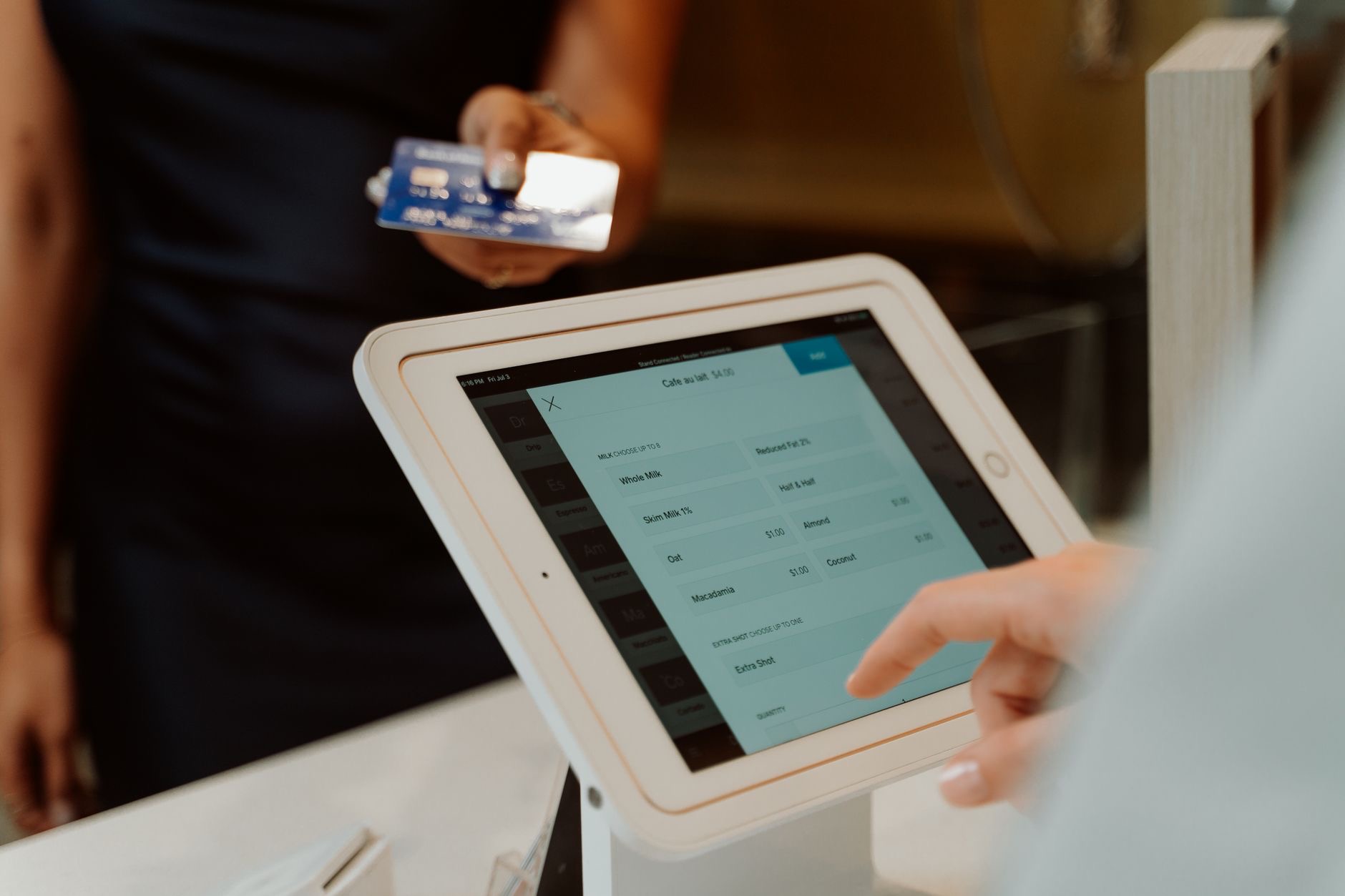 A person tapping a tablet screen