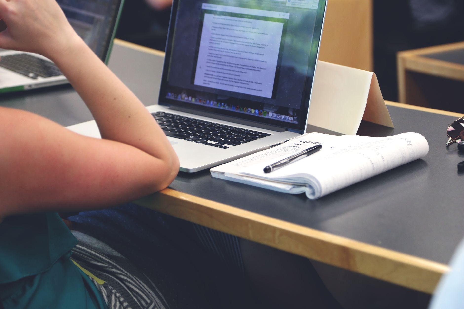 A laptop and notebook on a study desk