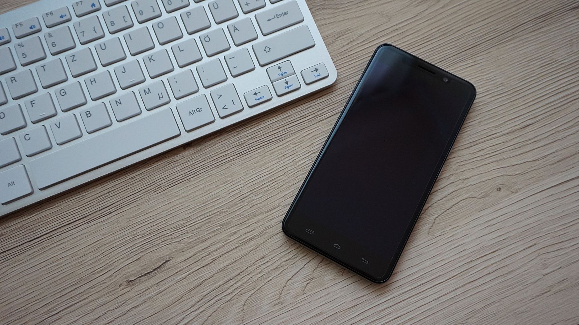 A smartphone on a wooden desk