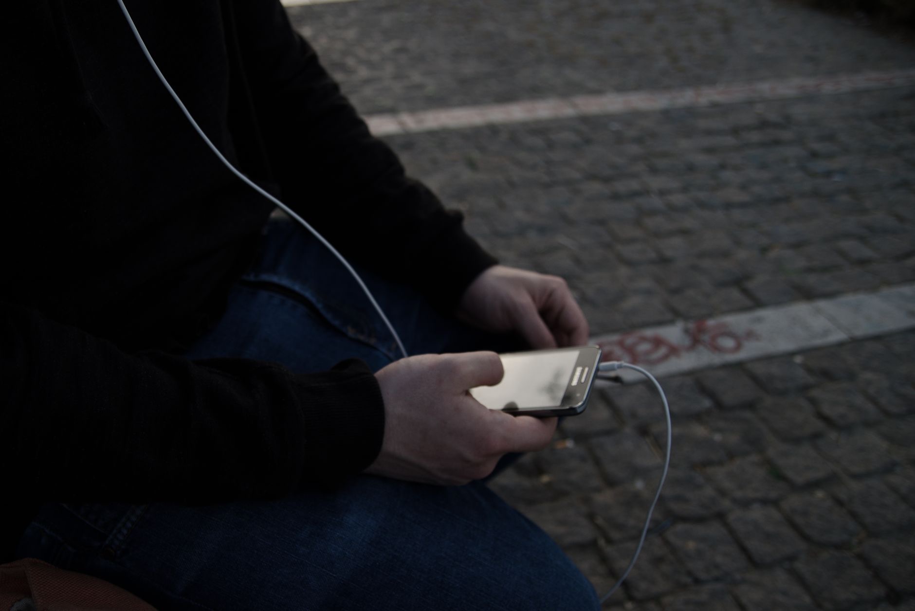 A person using a smartphone for music
