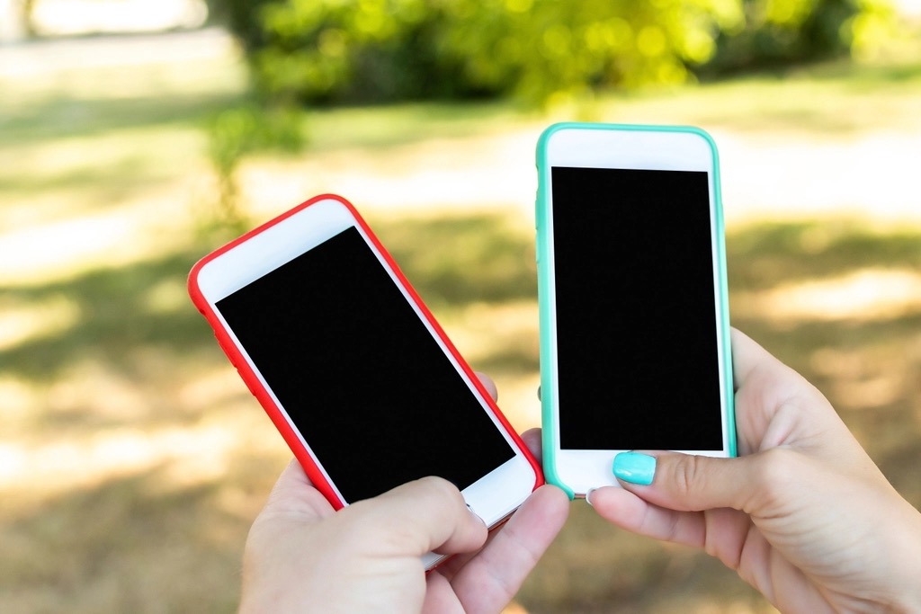 Two smartphones side by side on a desk
