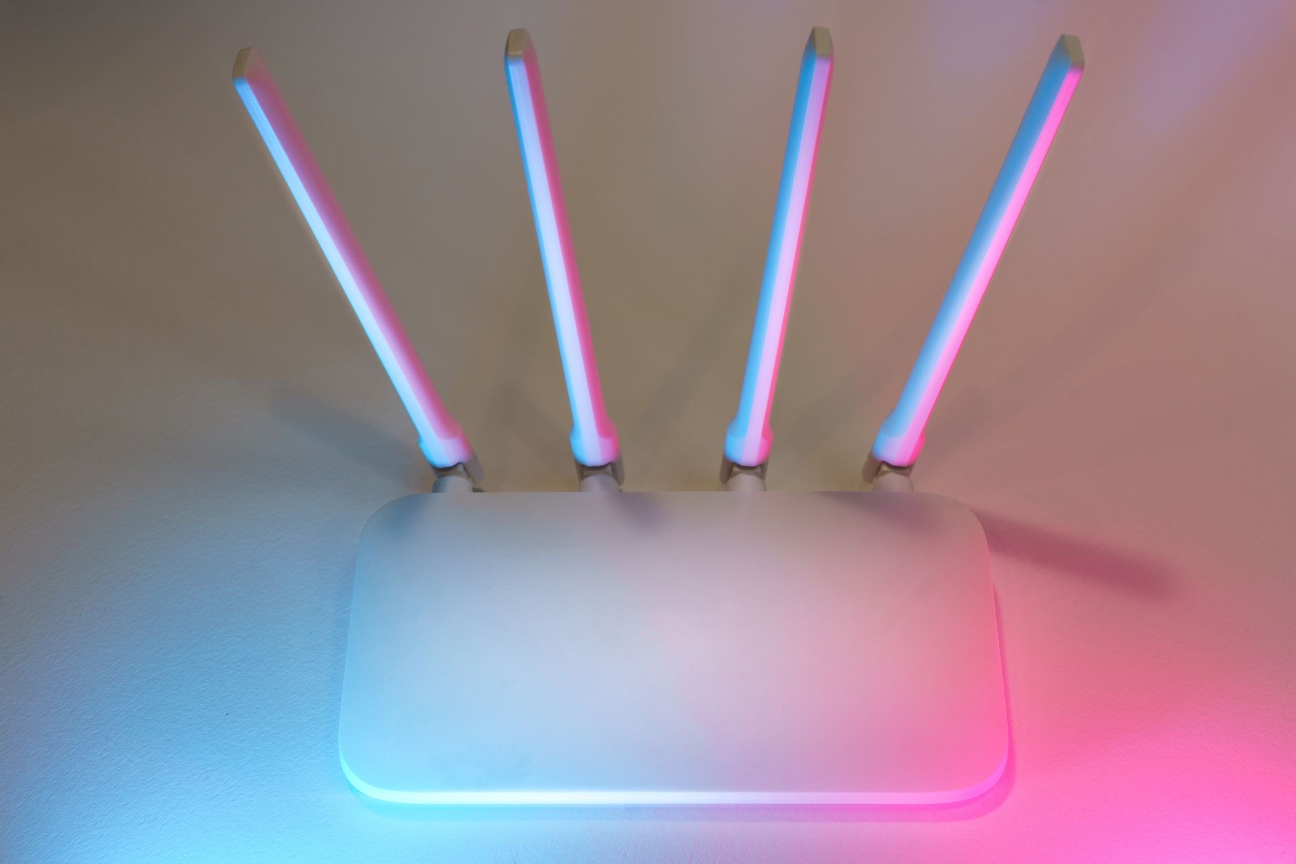 A Wi-Fi router with status lights on a shelf