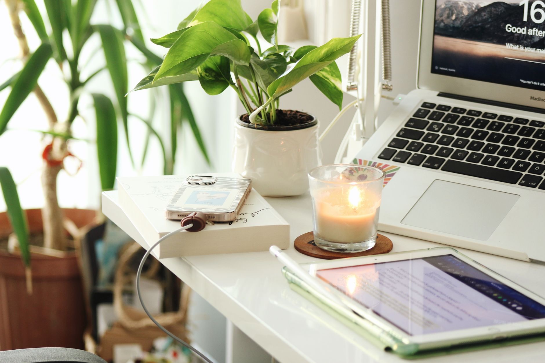 A laptop connected to a charger on a desk