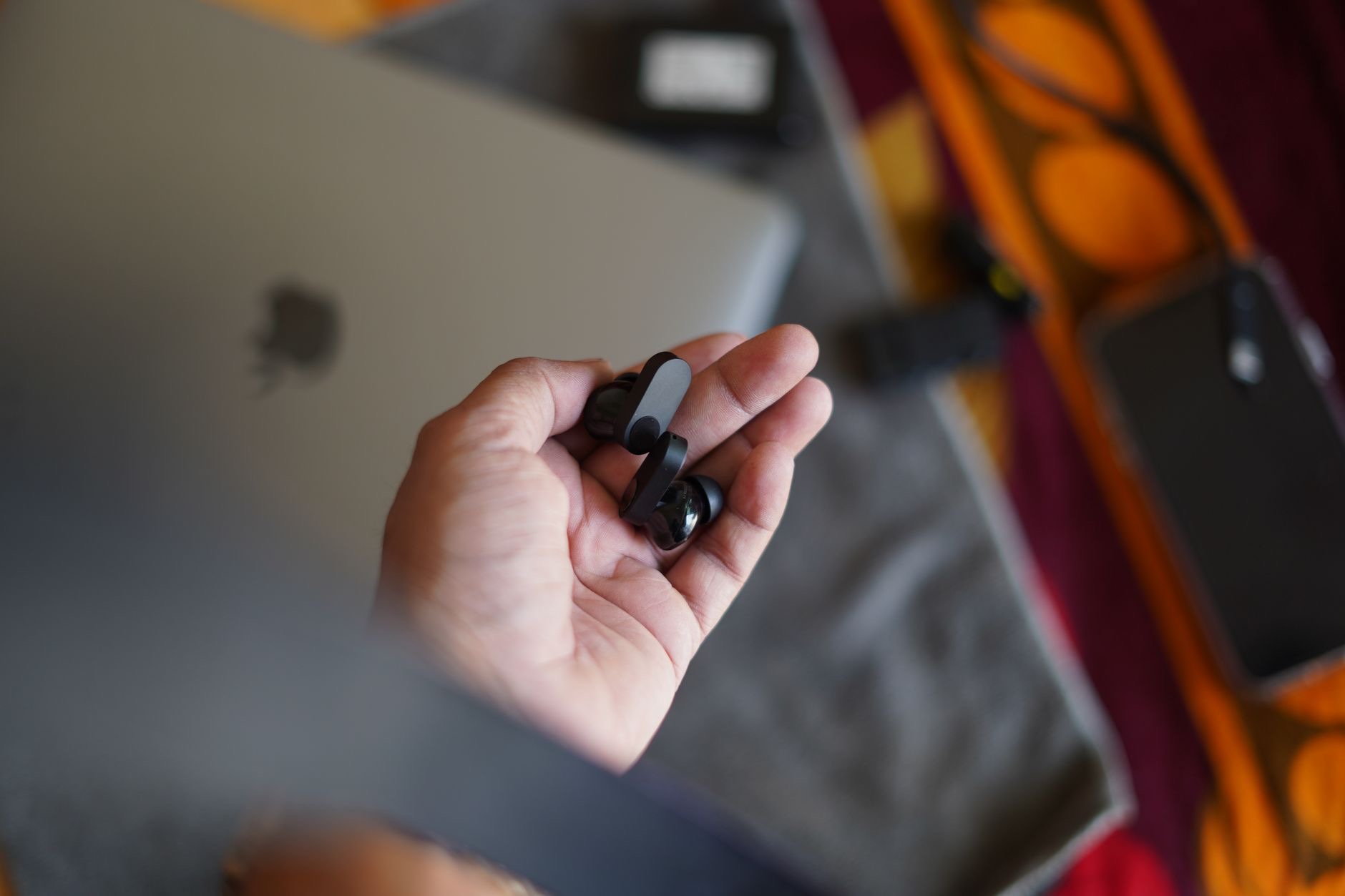 Holding wireless earbuds to check if they are genuine