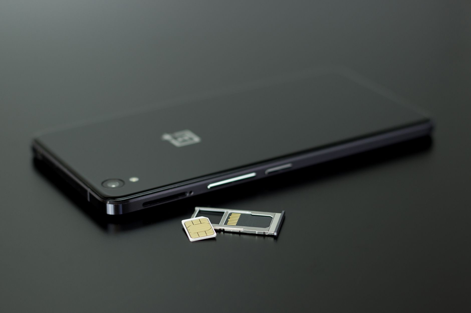 A SIM card beside a smartphone for international use