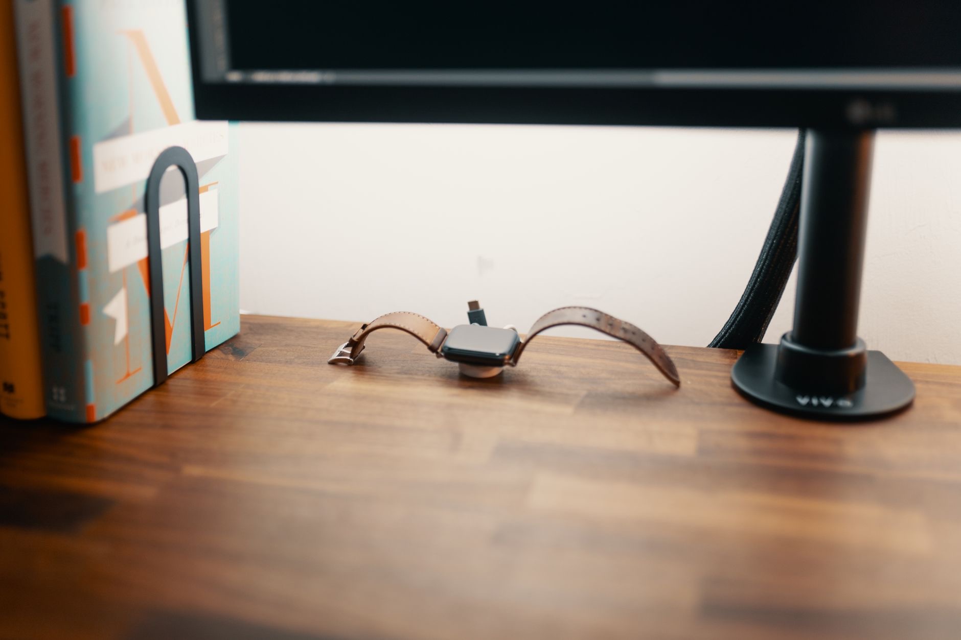 A watch charging on a stand at night