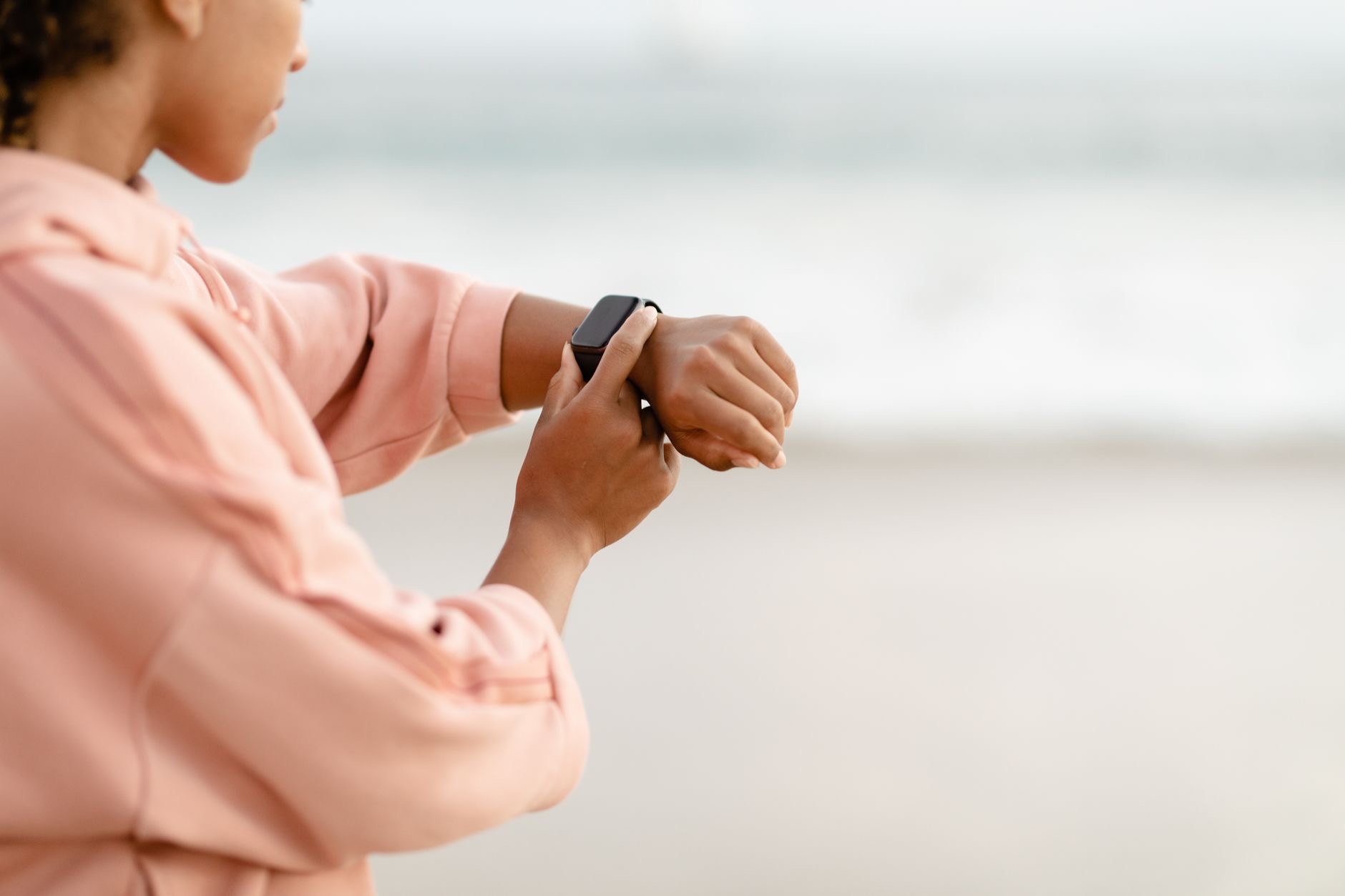 Person wearing a smartwatch outdoors