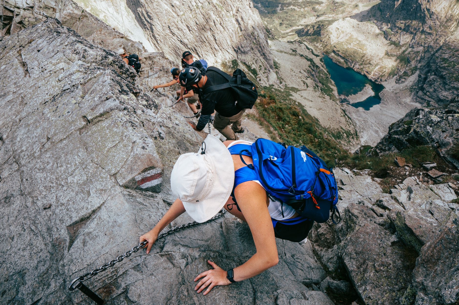 A hiker checking their watch on a trail