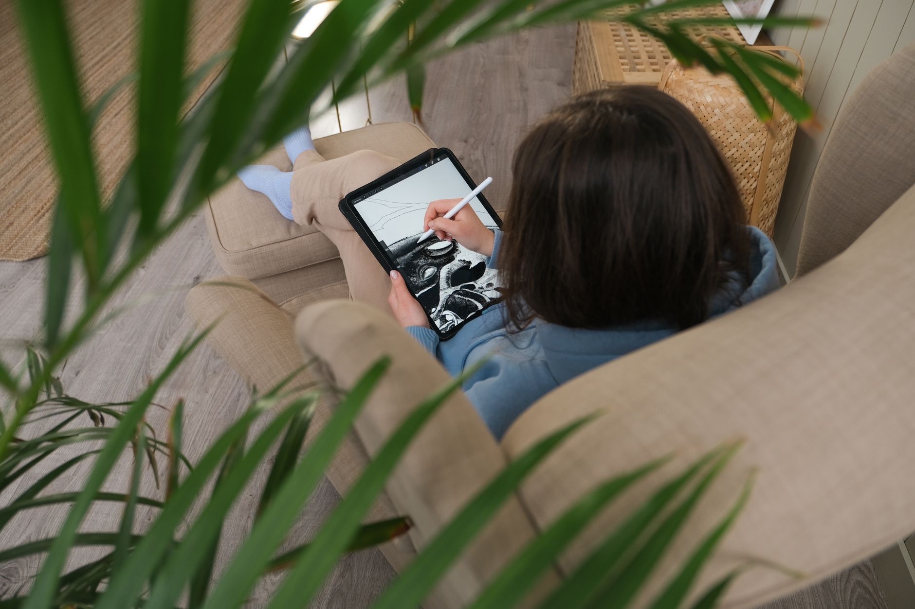 Person drawing on an iPad with a stylus