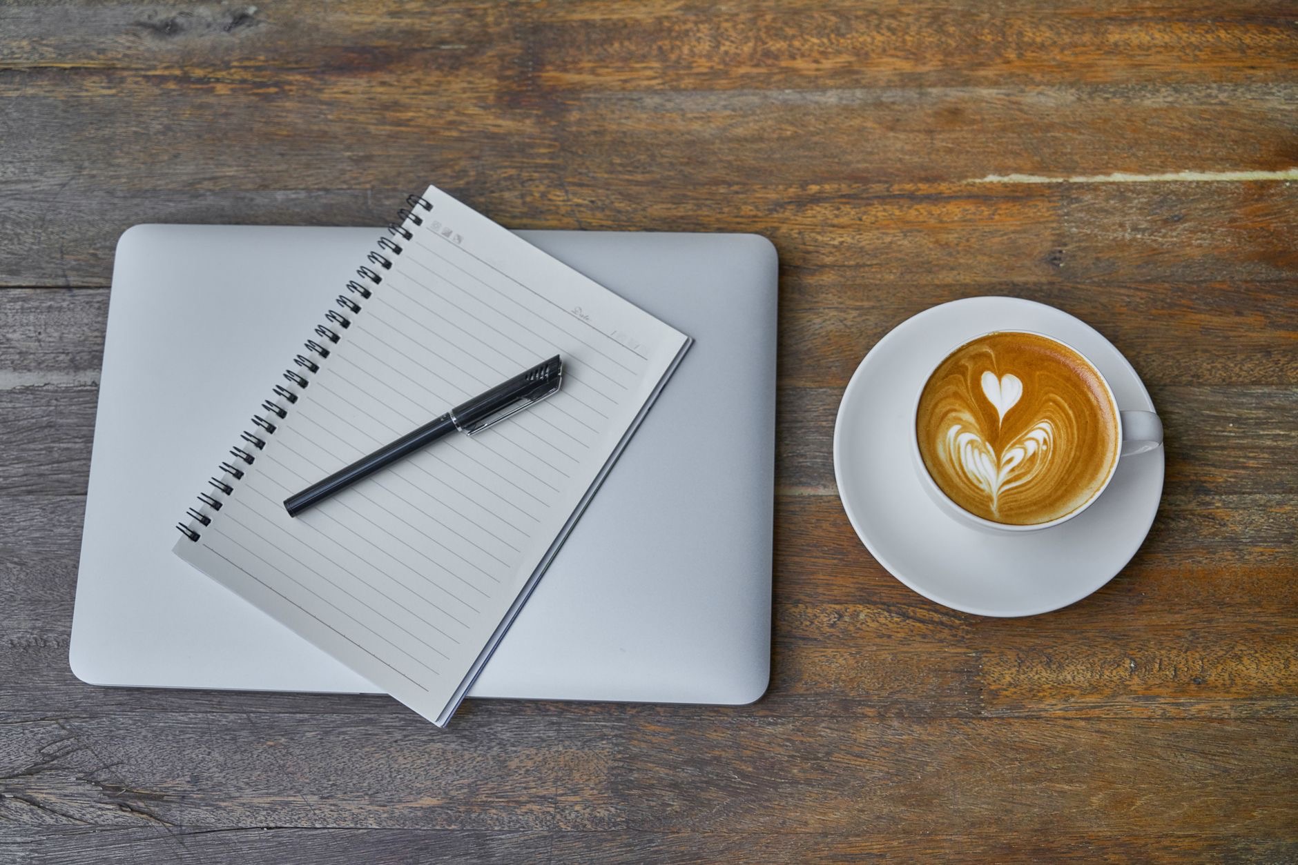 Close-up of a laptop and a coffee
