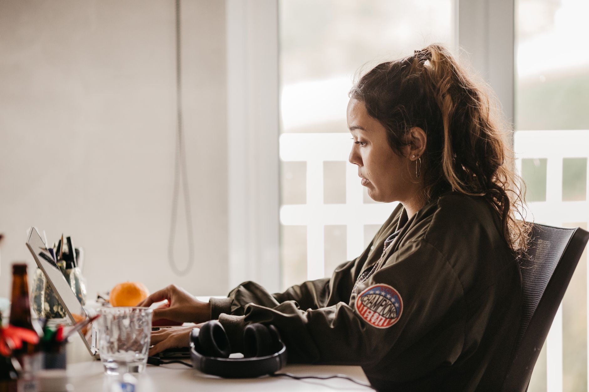 Person typing thoughtfully on a laptop