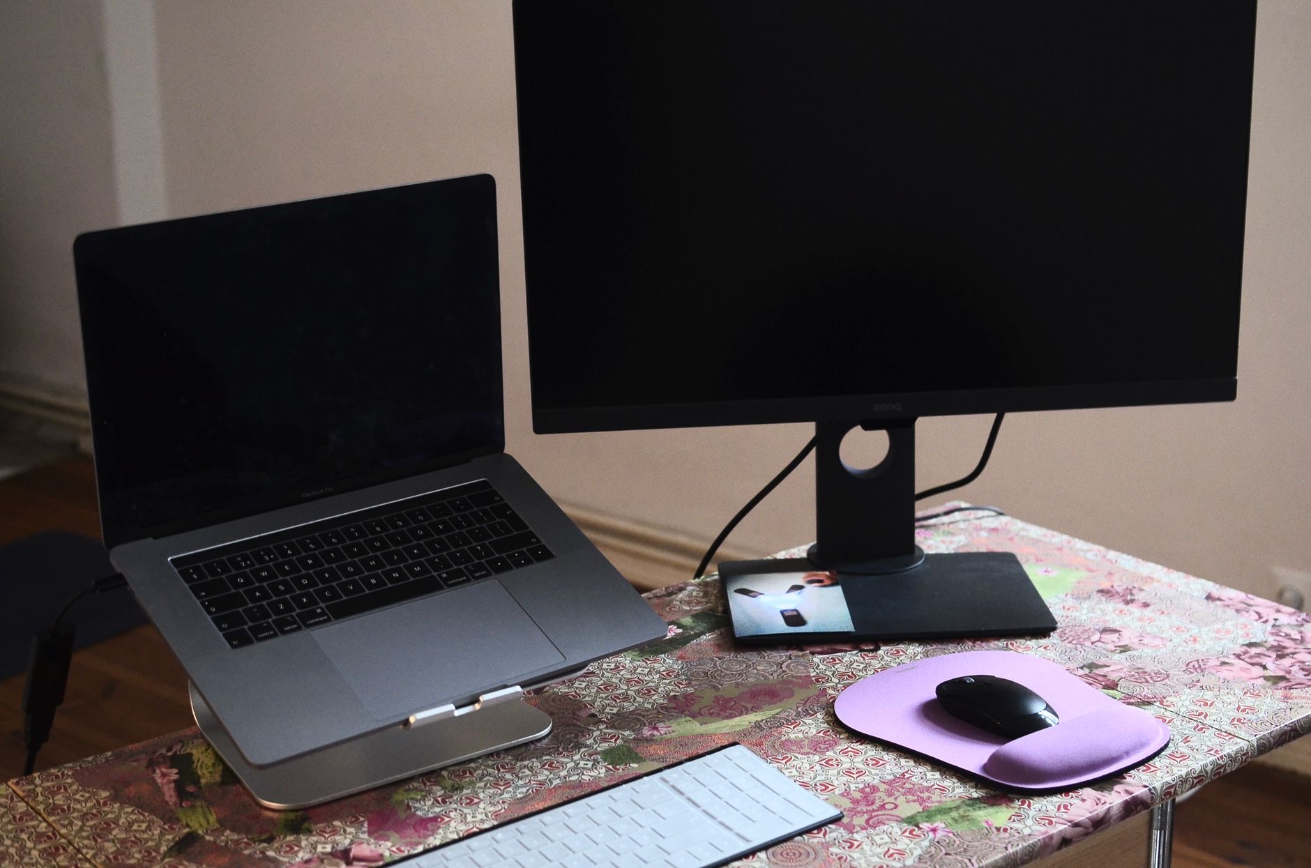 A laptop on a stand with keyboard