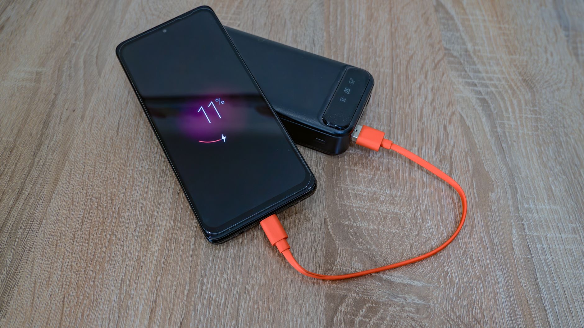 A portable power bank charging a phone