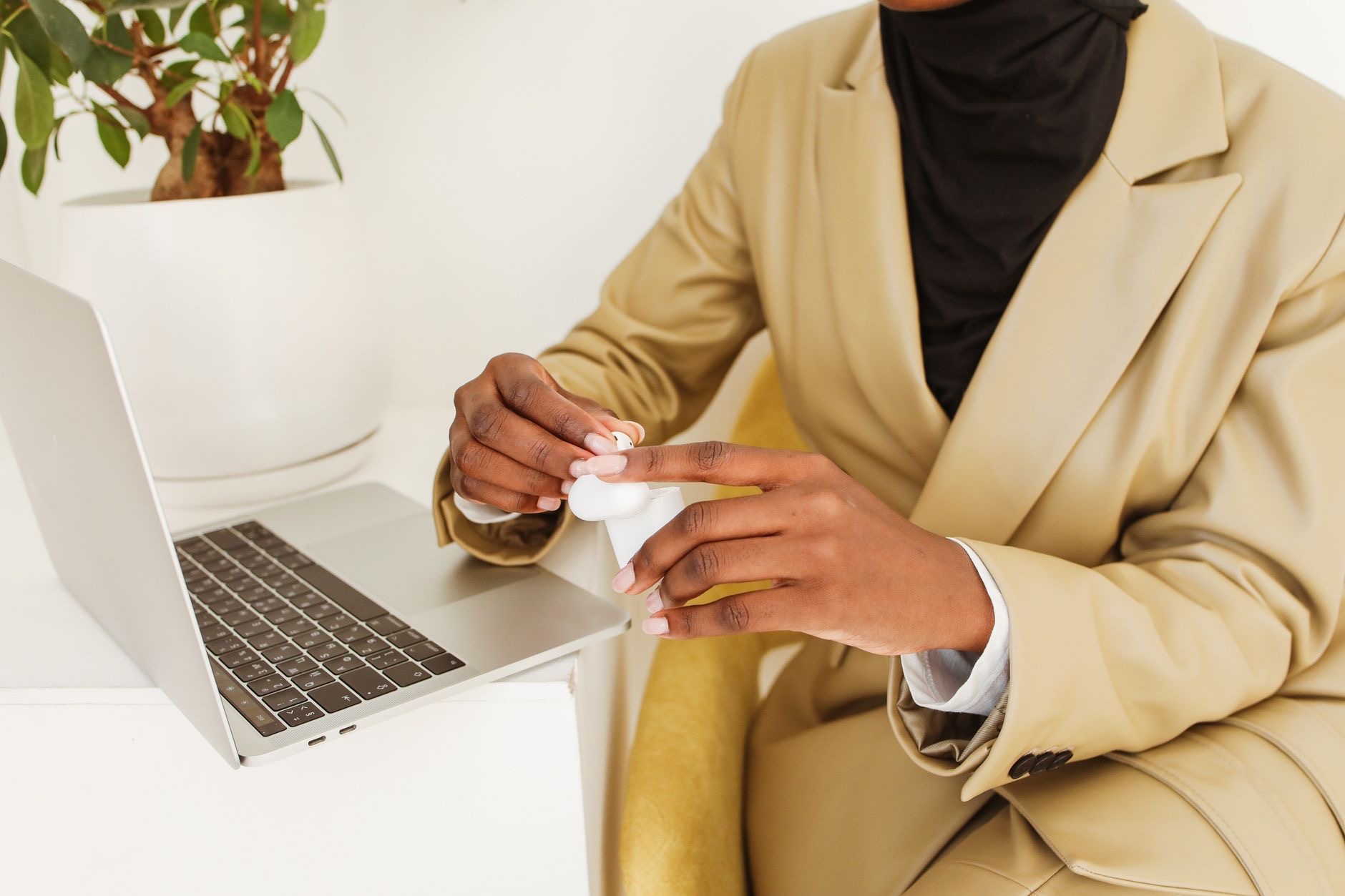 Working on a Mac wearing earbuds