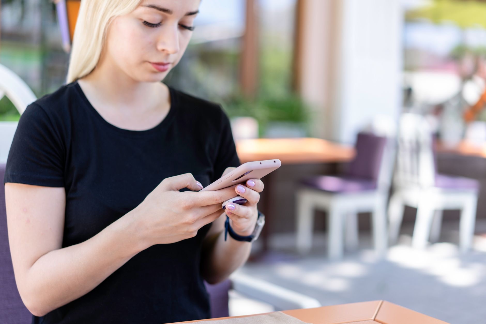 Someone using a phone at a cafe