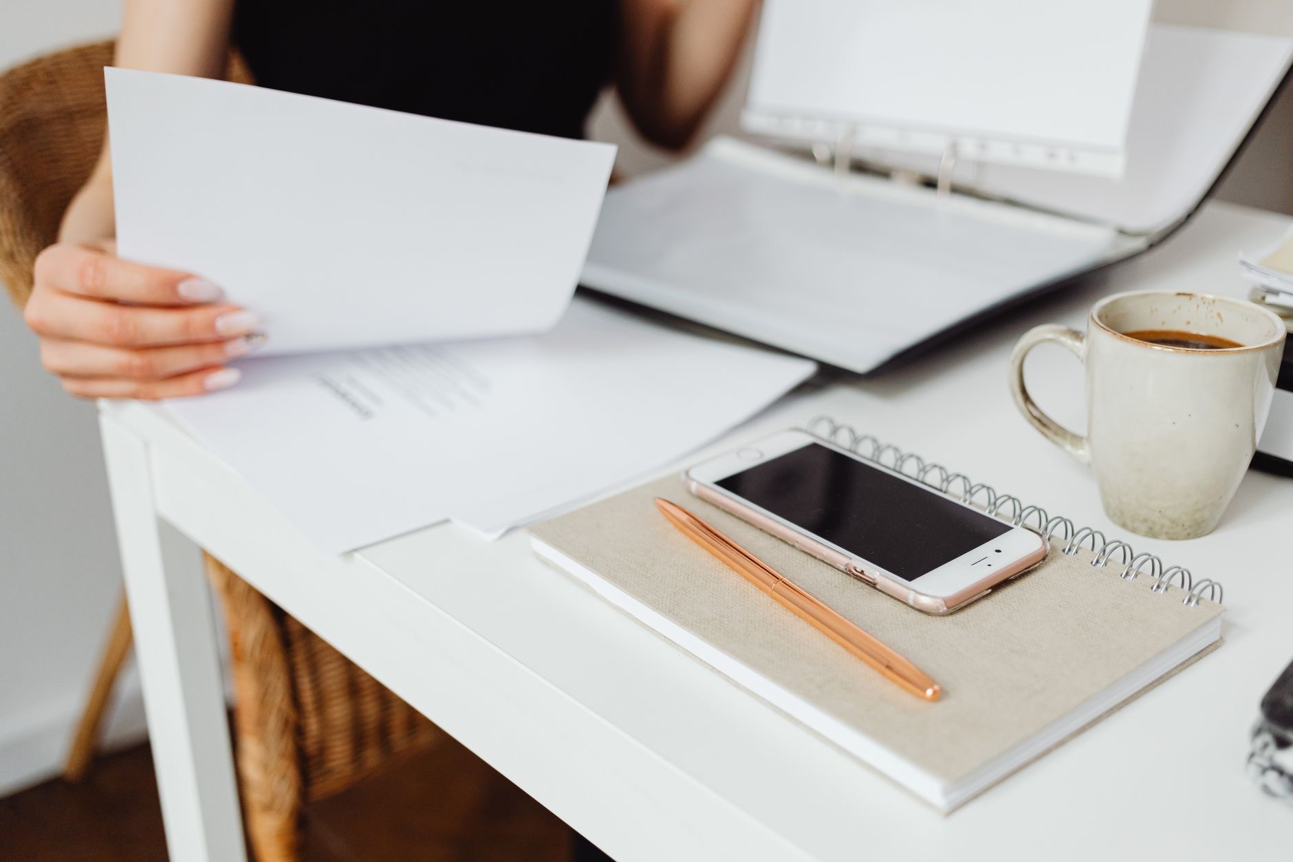 A tidy desk with papers and a phone
